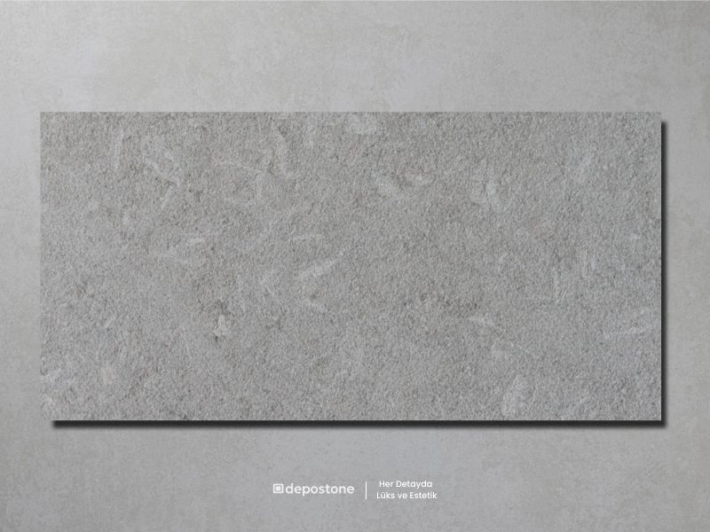 Crema Olive Marble tile featuring a sandblasted finish and olive green undertones with fossils.